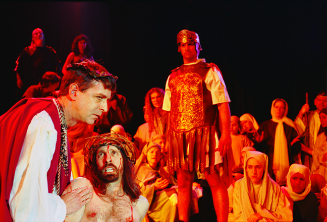 Jesus looks at Herod, after being beaten, wearing crown of thorns on stage in Jesus Christ Superstar