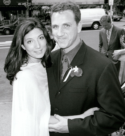 Erin and Blaze in black and white portrait pause outside the church, before walking to their New York City wedding reception