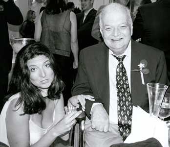 Erin and her father in a black and white photo of them seated during cocktail hour