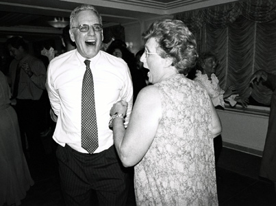 Bridegroom's parents dancing at wedding reception, black and white photograph