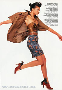 Karina Lombard in a camoflague skirt by Azzedine Alia, landing from a jump in a studio fashion photograph by fashion photographer Steve Landis