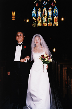 Bride walks down the aisle with her father at her wedding