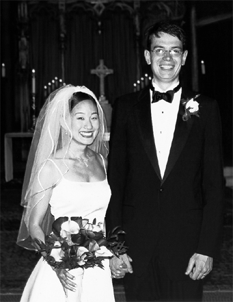 Smiling bride and groom in black and white photograph by Steve Landis after the wedding ceremony in the New York church.